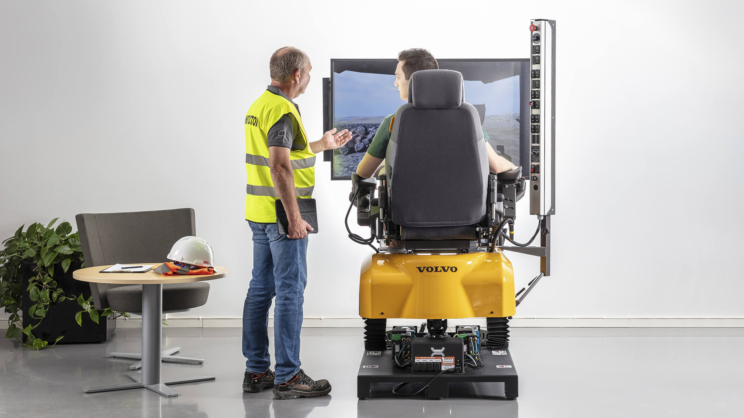 Volvo operator instructor using a Volvo Simulator in training